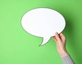 Woman holding blank speech bubble on green background, closeup. Space for text Royalty Free Stock Photo