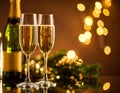 Brown background with blurry light on glasses of champagne and bottle on mirror surfa Royalty Free Stock Photo