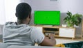 The man who watches modern TV with a green screen at home Royalty Free Stock Photo