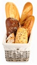 Different loaves of fresh bread in basket isolated on white Royalty Free Stock Photo