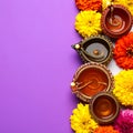Diwali celebration. Diya lamps and beautiful flowers on colorful background, closed. Royalty Free Stock Photo