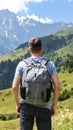 Tourist with backpack in mountains, back view Royalty Free Stock Photo
