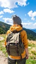 Tourist with backpack in mountains, back view Royalty Free Stock Photo