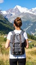 Tourist with backpack in mountains, back view Royalty Free Stock Photo