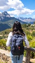 Tourist with backpack in mountains, back view Royalty Free Stock Photo