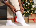 Man putting on white socks at home, closeup Royalty Free Stock Photo
