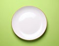 One ceramic plate on color background, top view Royalty Free Stock Photo