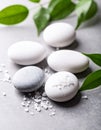 Spa stones, sea salt and leaves on grey table Royalty Free Stock Photo
