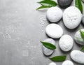 Spa stones, sea salt and leaves on grey table Royalty Free Stock Photo