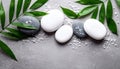 Spa stones, sea salt and leaves on grey table Royalty Free Stock Photo