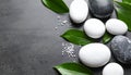 Spa stones, sea salt and leaves on grey table Royalty Free Stock Photo