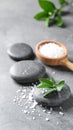 Spa stones, sea salt and leaves on grey table Royalty Free Stock Photo