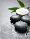 Spa stones, sea salt and leaves on grey table Royalty Free Stock Photo