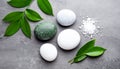 Spa stones, sea salt and leaves on grey table Royalty Free Stock Photo