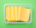 Pack of sliced, Cheese on green background, top view Royalty Free Stock Photo