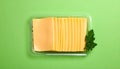 Pack of sliced, Cheese on green background, top view Royalty Free Stock Photo