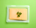 Pack of sliced, Cheese on green background, top view Royalty Free Stock Photo