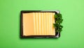 Pack of sliced, Cheese on green background, top view Royalty Free Stock Photo