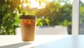 Plastic takeaway cup of delicious iced coffee on white table under sunlight, Royalty Free Stock Photo