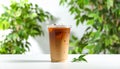 Plastic takeaway cup of delicious iced coffee on white table under sunlight, Royalty Free Stock Photo