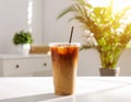 Plastic takeaway cup of delicious iced coffee on white table under sunlight, Royalty Free Stock Photo