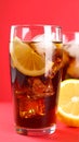Glass of refreshing soda drink with ice cubes and lemon on red background, closeup Royalty Free Stock Photo