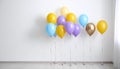 Balloon garland near white wall in room. Festive decor Royalty Free Stock Photo