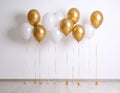 Balloon garland near white wall in room. Festive decor Royalty Free Stock Photo