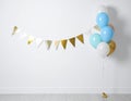 Balloon garland near white wall in room. Festive decor Royalty Free Stock Photo
