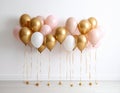 Balloon garland near white wall in room. Festive decor Royalty Free Stock Photo