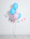 Balloon garland near white wall in room. Festive decor Royalty Free Stock Photo