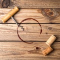 Wine stain, corkscrew and stopper on wooden table, flat lay. Royalty Free Stock Photo