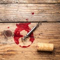 Wine stain, corkscrew and stopper on wooden table, flat lay. Royalty Free Stock Photo