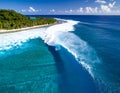 A powerful teahupoo wave, famous for surfing, looms with crystal blue waters Royalty Free Stock Photo