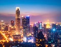 Bright glowing lights of district in megapolis under dusk sky in evening on blurred Royalty Free Stock Photo