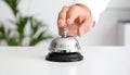 Man ringing hotel service bell at light table Royalty Free Stock Photo