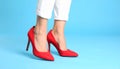 Woman wearing red high heeled shoes on light blue background, closeup Royalty Free Stock Photo