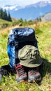 Backpack, hat and trekking shoes on grass in the open air Royalty Free Stock Photo