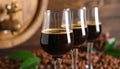 Glasses of coffee liqueur on blurred background, closeup Royalty Free Stock Photo