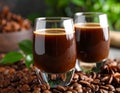 Glasses of coffee liqueur on blurred background, closeup Royalty Free Stock Photo