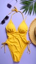 Flat lay composition with yellow swimsuit, hat and sunglasses on purple background Royalty Free Stock Photo