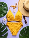 Flat lay composition with yellow swimsuit, hat and sunglasses on purple background Royalty Free Stock Photo