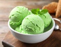 Delicious green ice cream served on wooden table, closeup Royalty Free Stock Photo