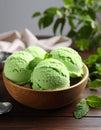 Delicious green ice cream served on wooden table, closeup Royalty Free Stock Photo