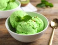 Delicious green ice cream served on wooden table, closeup Royalty Free Stock Photo