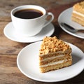 Pieces of delicious Kyiv Cake served with coffee on wooden table Royalty Free Stock Photo