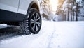 Snow tire near car on road in winter Royalty Free Stock Photo