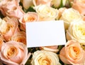 Bouquet of beautiful roses with blank card, closeup Royalty Free Stock Photo