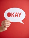 Woman holding paper speech bubble with word Okay on red background, closeup Royalty Free Stock Photo