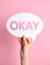 Woman holding paper speech bubble with word Okay on pink background, closeup Royalty Free Stock Photo